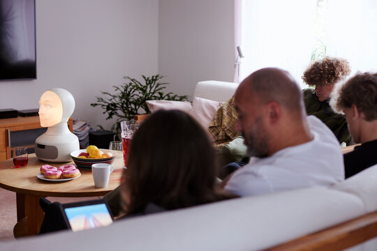 Family sitting on sofa in living room