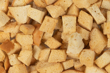 Background texture of baked crackers. heap small pieces dried bread. crumbs of bread croutons