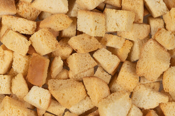 Background texture of baked crackers. heap small pieces dried bread. crumbs of bread croutons