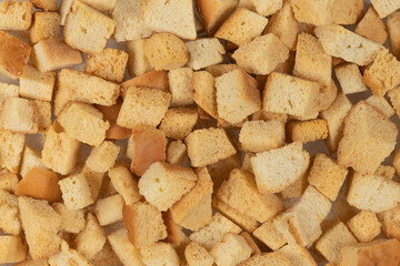 Background texture of baked crackers. heap small pieces dried bread. crumbs of bread croutons