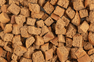 Background texture of baked crackers. heap small pieces dried bread. crumbs of bread croutons