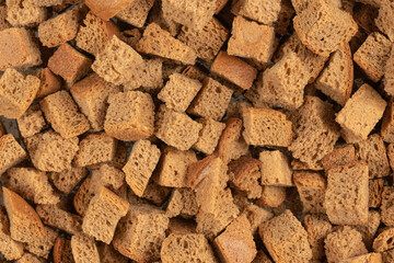 Background texture of baked crackers. heap small pieces dried bread. crumbs of bread croutons