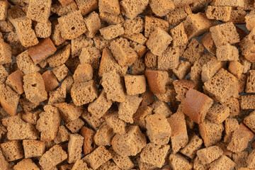 Background texture of baked crackers. heap small pieces dried bread. crumbs of bread croutons