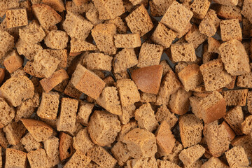 Background texture of baked crackers. heap small pieces dried bread. crumbs of bread croutons