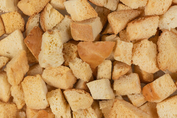 Background texture of baked crackers. heap small pieces dried bread. crumbs of bread croutons