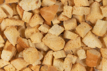 Background texture of baked crackers. heap small pieces dried bread. crumbs of bread croutons