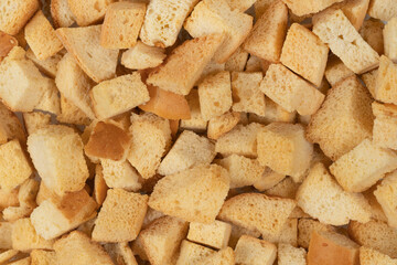 Background texture of baked crackers. heap small pieces dried bread. crumbs of bread croutons