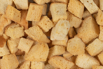 Background texture of baked crackers. heap small pieces dried bread. crumbs of bread croutons