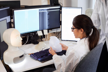 Student and teacher working with illuminated face model