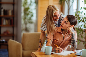 Lesbian woman hugging her partner at home