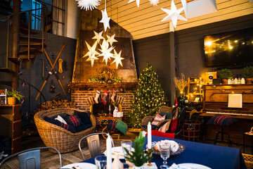 evening. beautiful room is decorated for New Year. fireplace with socks for gifts.