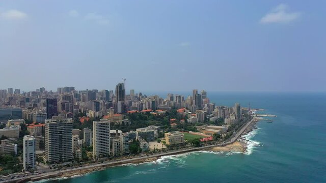 Aerial Panning Beautiful Shot Of Tall Buildings Against Sky, Drone Flying Over Sea In City - Beirut, Lebanon