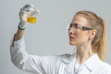 Chemical test tubes and flasks with petroleum products, the girl