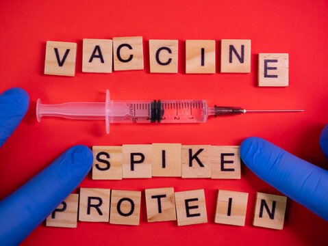 Omicron Variant Displaces Delta. Emergence Of New Dangerous Strain Of Coronavirus COVID-19 Omicron. Words Vaccine Spike Protein On Colored Red Background