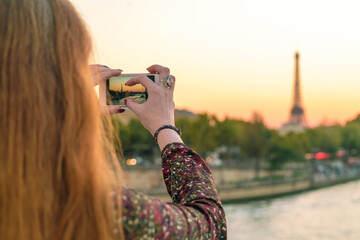 France, Paris, Woman taking photo with mobile phone