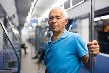 Fototapeta na wymiar Portrait of man traveling by modern city subway car
