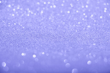 Defocused trendy violet glittering background with shinig bokeh.