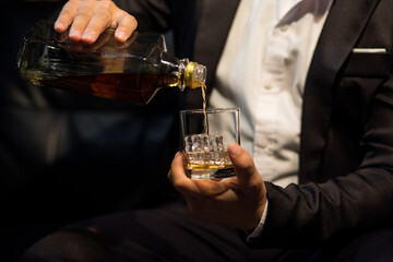 Barman pouring whiskey whiskey glass beautiful night