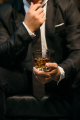 Businessmen in suits drinking whiskey