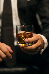 Businessmen in suits drinking whiskey