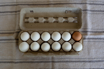 Closeup shot of brown and white eggs in a flat