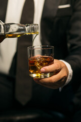 Businessmen in suits drinking whiskey