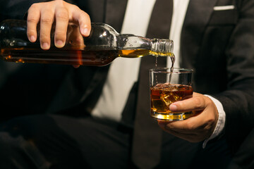 Businessmen in suits drinking whiskey