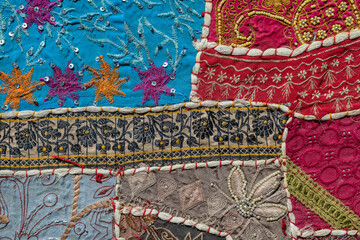 Detail old colorful patchwork carpet in India. Close up