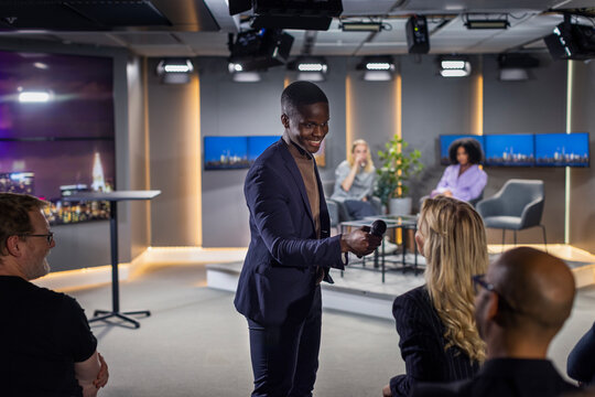 TV show host interviewing audience member