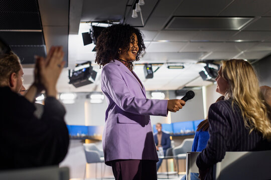 TV show host interviewing audience member