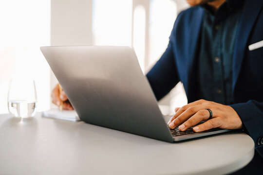 Man's hands on laptop keyboard
