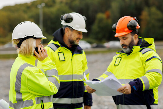 Engineers in reflective clothing discussing plans