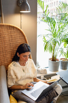Young woman using laptop in cafe