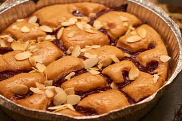 Freshly baked cherry pie with chopped almonds