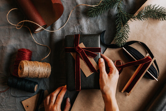 High angle view of womans hands holding wrapped present