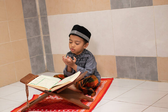 Handsome Asian boys are praying and studying al-qur'an