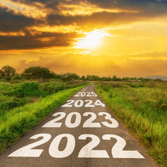 New Year 2022 Goals Concept : Empty asphalt road sunrise with text go to New year 2022