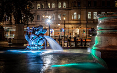 A night view of fountains of Trafalgar square, a public square in the City of Westminster, Central London