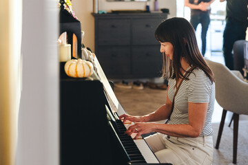 Woman Practicing Piano At Home