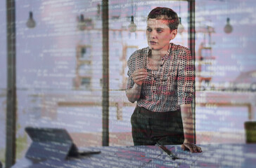Thoughtful businesswoman leaning near desk with binary codes on glass