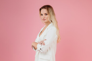 beautiful girl in a white suit on a pink background
