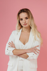 beautiful girl in a white suit on a pink background
