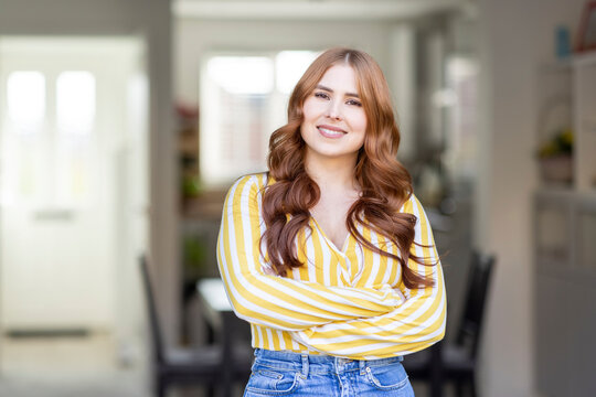 Smiling Beautiful Redhead Woman Standing With Arms Crossed