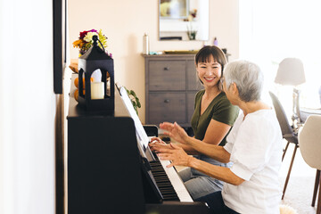 Cheerful Family Learning Piano At Home