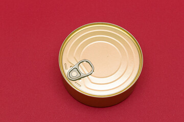 Unopened Tin Can with Blank Edge on Red Background. Canned Food. Aluminum Can for Safe and Long Term Storage of Food. Steel Sealed Food Storage Container