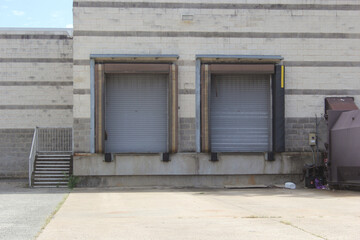 Obraz na płótnie Canvas Garage Door on Warehouse and Regular Door
