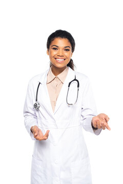 Positive african american doctor in white coat looking at camera isolated on white.