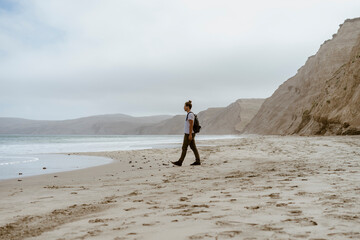 Man walking near sea on beach at Point Reyes in California, USA