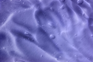 Color of the year 2022. Texture of transparent light violet blue gel with air bubbles and waves on soft background. Concept of skin moisturizing and prevention of covid. Liquid beauty product closeup - obrazy, fototapety, plakaty