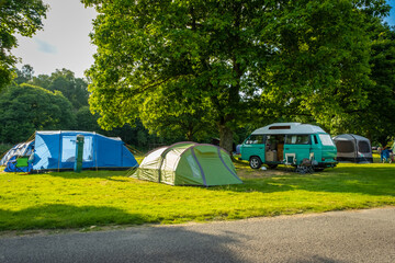Camper vans and tents pitched at a camp site during the summer